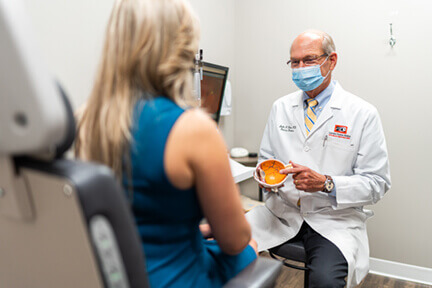 Doctor showing patient model of eye